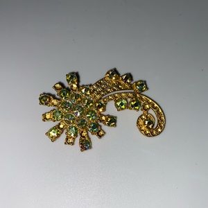 Vintage gold colored pin/brooch with iridescent green and blue gems